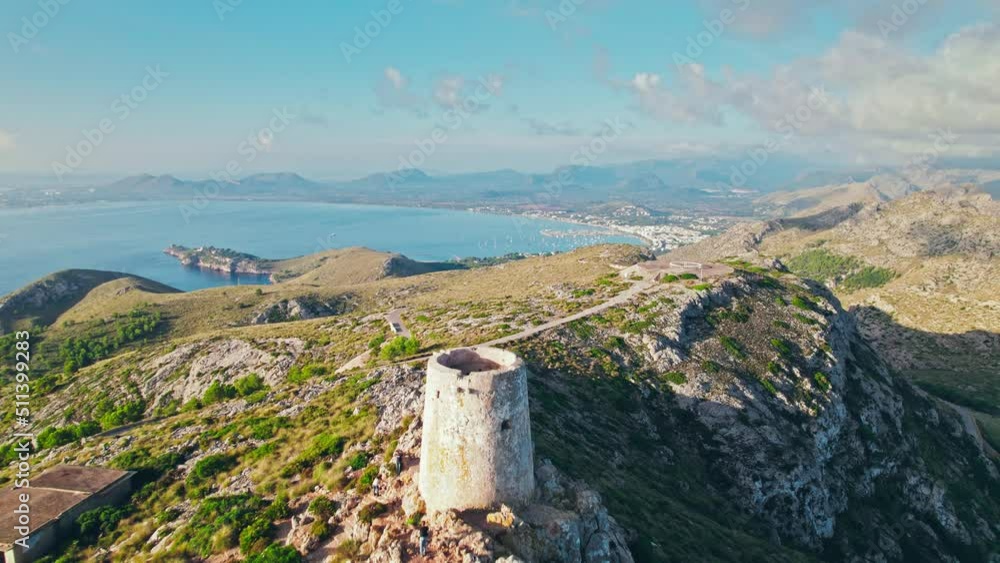 Scenic views of a sunrise over the peak of Serra de Tramuntana in Majorca, Spain. Albercutx Watchtower - a Tower built to spot pirates, with sweeping cape and bay views on Balearic Islands, Spain. Scenic views of a sunrise over the peak of Serra de Tramuntana in Majorca, Spain. Albercutx Watchtower - a Tower built to spot pirates, with sweeping cape and bay views on Balearic Islands, Spain.