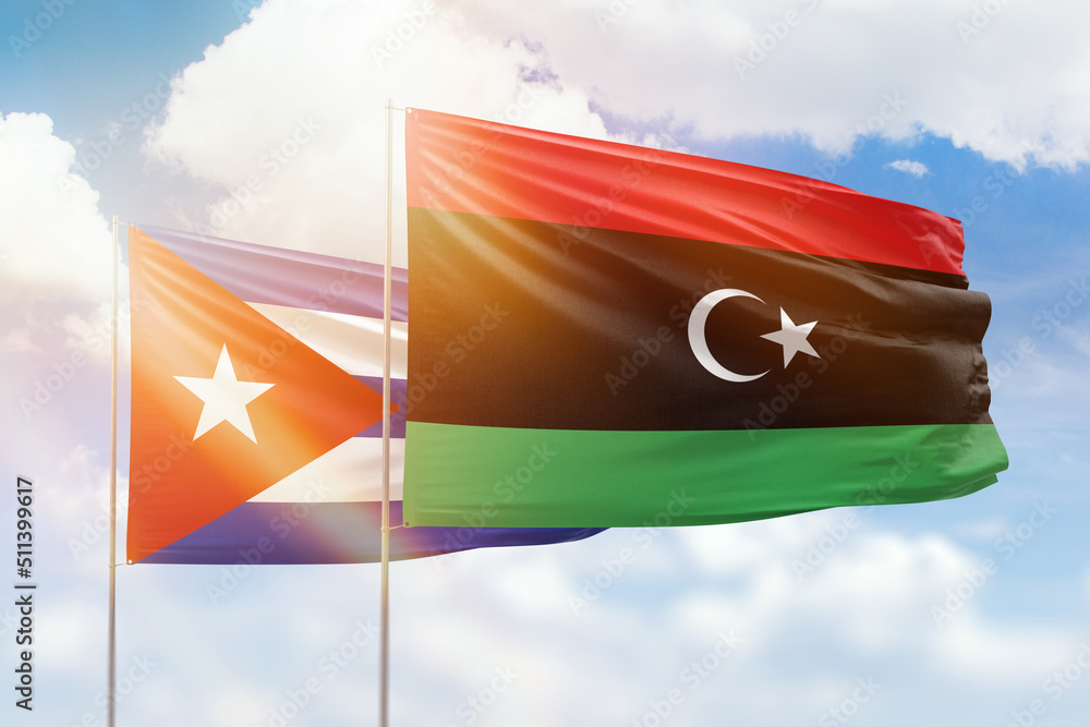 Sunny blue sky and flags of libya and cuba Sunny blue sky and flags of libya and cuba