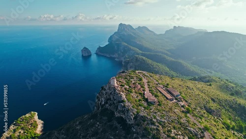 Scenic views of a sunrise over the peak of Serra de Tramuntana in Majorca, Spain. Albercutx Watchtower - a Tower built to spot pirates, with sweeping cape and bay views on Balearic Islands, Spain. photo