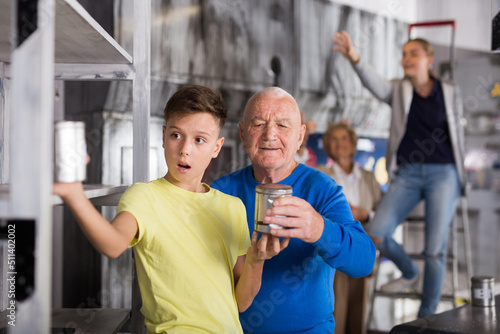 Caucasian grandparents and grandchildren resolving conundrum in quest room.