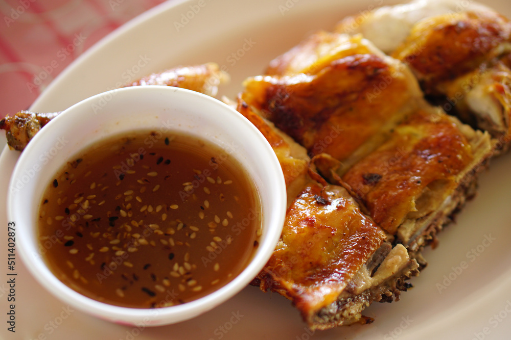 Grilled chicken with dipping sauce on a plate Grilled chicken with dipping sauce on a plate