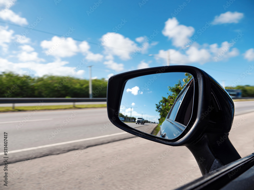 Car rearview mirror. Outdoor on the road