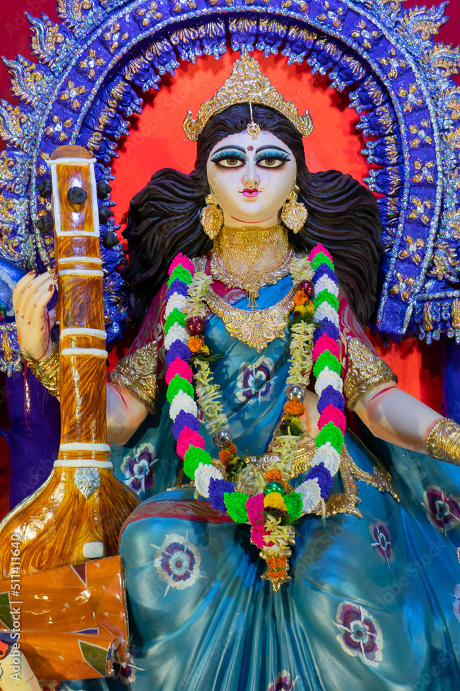 Idol of Goddess Saraswati with veena, a musical instrument, at Kolkata, West Bengal, India. Saraswati is Hindu goddess of knowledge, music, art, wisdom, and learning.