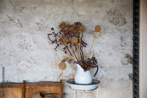 enamel jug with dried flower arrangement photo