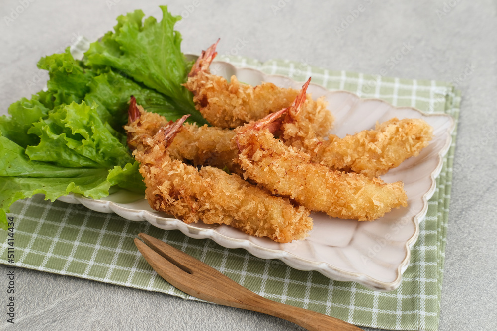 Fried breaded shrimp with vegetable on plate, served with chilli sauce
Fried breaded shrimp with vegetable on plate, served with chilli sauce