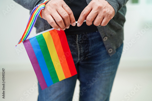 Asian woman with rainbow flag, LGBT symbol rights and gender equality, LGBT Pride Month in June.