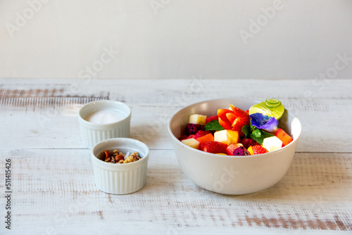 fruit salad on light wooden background