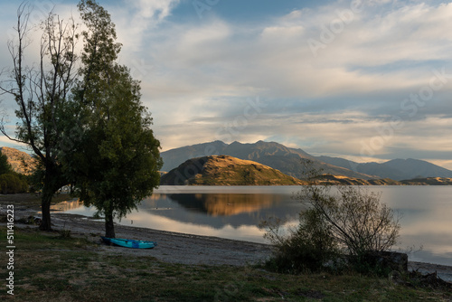 An early morning view from Glendhu Bay on Lake Wanaka across to Roy's Peninsula with the mountains of mount Aspiring National Park in the.background. Otago, South Island, New Zealand. photo
