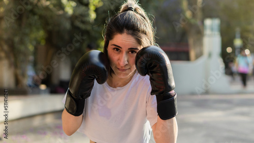 Portrait of a beautiful Caucasian woman finishing her boxing classes. © Daniel