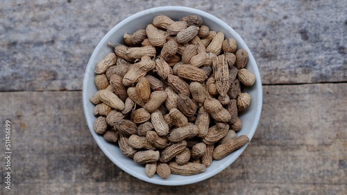 A bowl of roasted peanuts unpeeled roasted peanuts