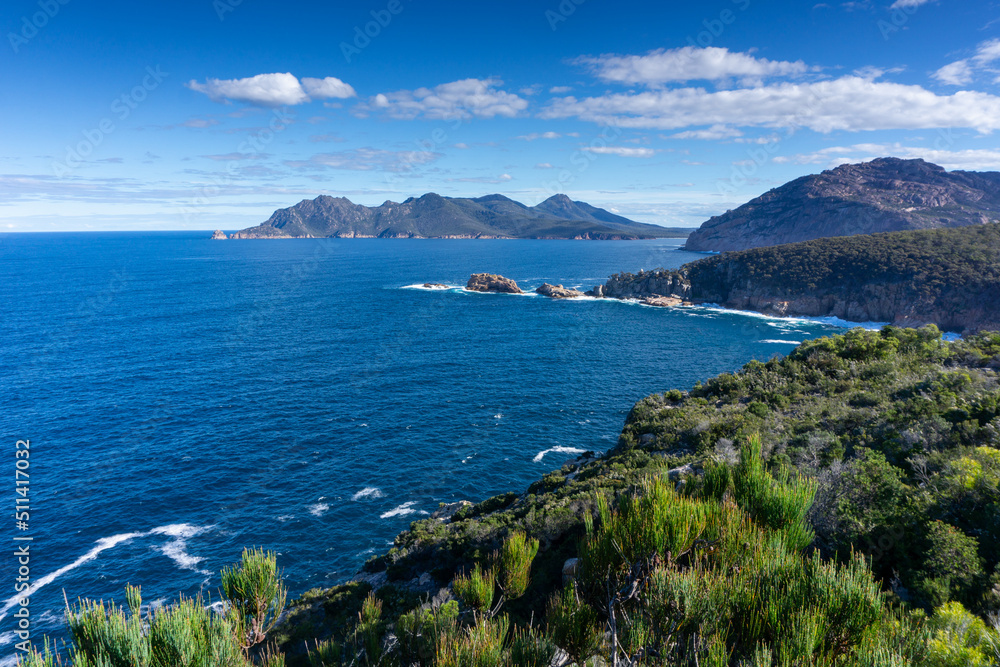 Freycinet Peninsula view with horizon and blue sky and clouds Freycinet Peninsula view with horizon and blue sky and clouds