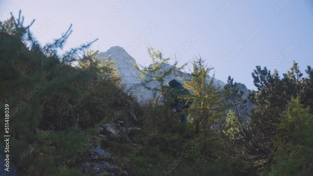 Backpacker Climbs Up the Hill, Reaches Top, Low Angle Slow Motion Shot Backpacker Climbs Up the Hill, Reaches Top, Low Angle Slow Motion Shot