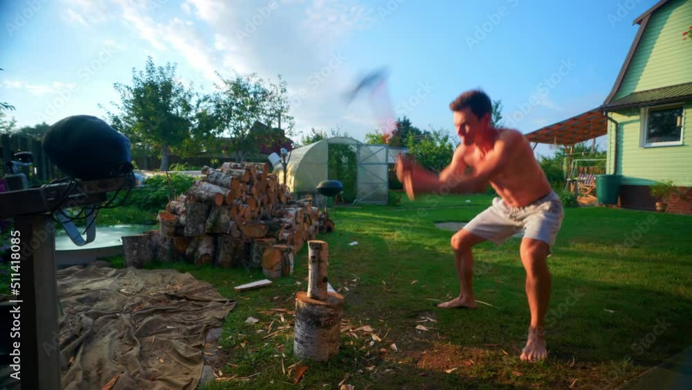 Shirtless Man Chopping Firewood On A Chopping Wood Block Using An Axe ...