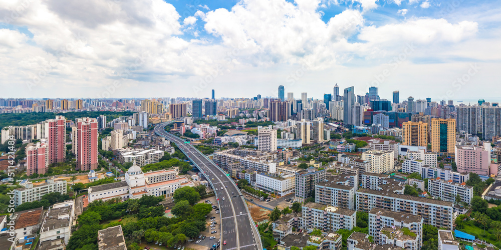 Fototapeta premium Haikou Cityscape with Landmark Buildings and Urban Overpass during Sunny Daytime, Hainan Province, the Largest Free Trade Zone in China.