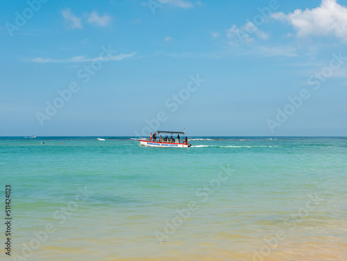 Hikkaduwa  Sri Lanka - March 8  2022  Beautiful view of the azure water of the Indian Ocean. Tourists are sailing in a boat for diving. Copy space