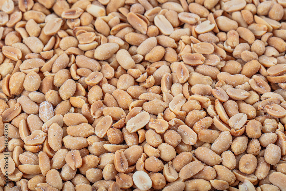 Roasted peanuts background. Seamless pattern of roasted peanuts. Close-up. View from above. Roasted peanuts background. Seamless pattern of roasted peanuts. Close-up. View from above.