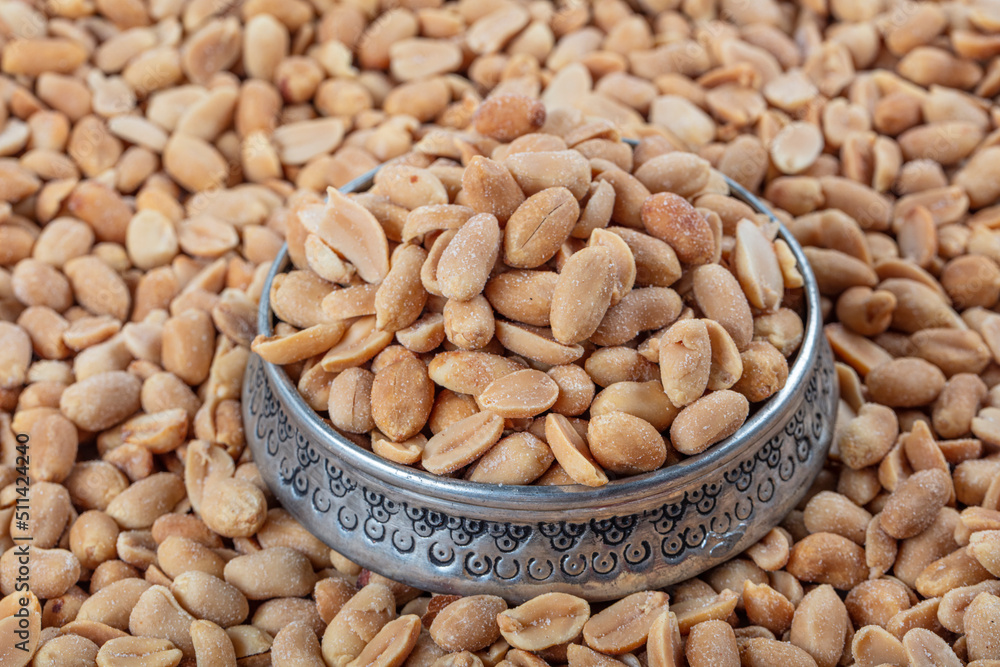 Roasted peanuts background. Seamless pattern of roasted peanuts. Close-up. View from above. Roasted peanuts background. Seamless pattern of roasted peanuts. Close-up. View from above.