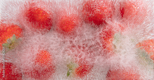 Strawberry frozen inside ice on white background.