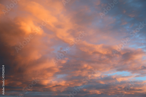 blue sky and many clouds with orange and pink colors