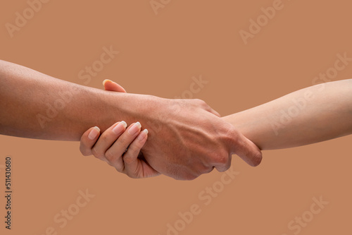 Hands of a man and woman at the time of rescue  isolated on brown backgrounds  Concept of salvation. 