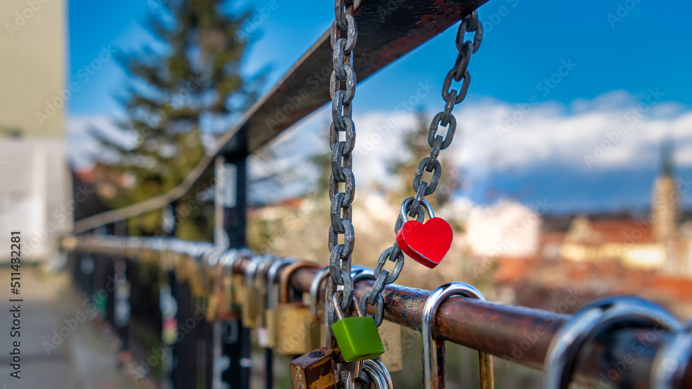 A heart-shaped padlock locked on the fence A heart-shaped padlock locked on the fence
