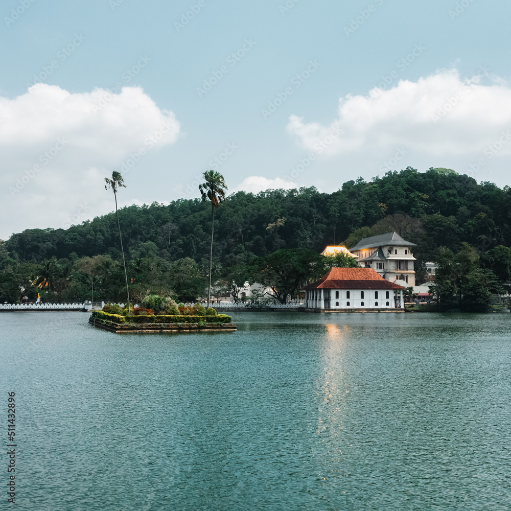 Fototapeta premium Skyline aerial drone view of Kandy lake and temple, stunning place in the heart of Kandy city in Sri Lanka. Famous historical and Buddhism landmark Sri Dalada Maligawa, Sacred Tooth Relic of Temple