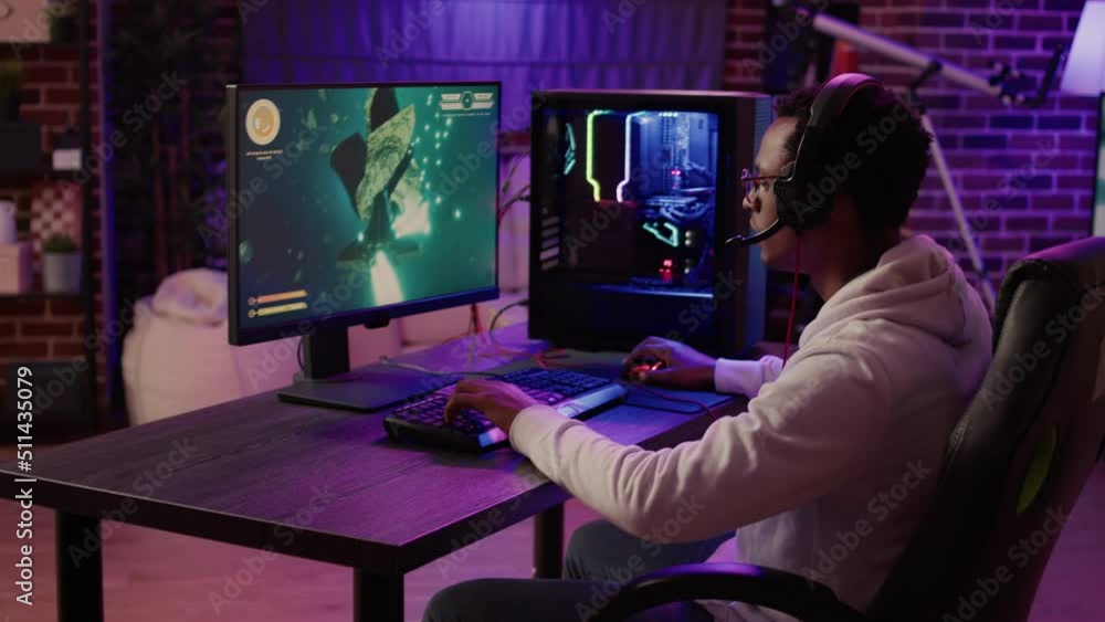 Gamer feeling unhappy after losing difficult level in online space shooter on gaming pc at home. African american man playing internet multiplayer game disappointed after failing competition. Gamer feeling unhappy after losing difficult level in online space shooter on gaming pc at home. African american man playing internet multiplayer game disappointed after failing competition.