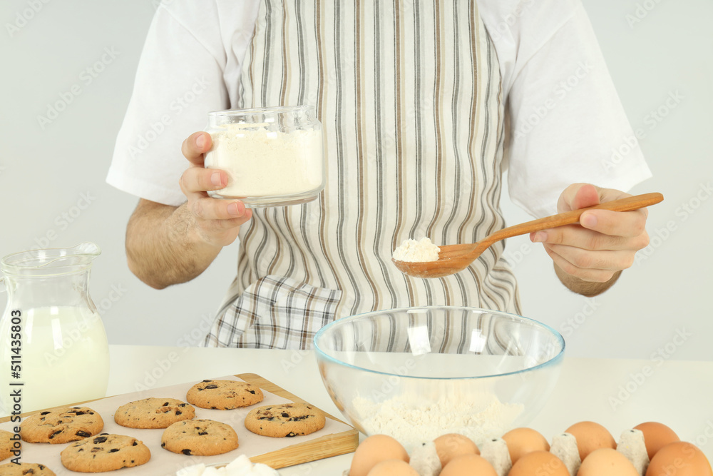 Concept of cooking, young man in apron cook cookies Concept of cooking, young man in apron cook cookies