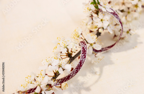 Latvian National Festive Decoration with Blooming Branch from the Ribbon of the Latvian Ribbon Belt Lielvarde for the Independence Day of Latvia