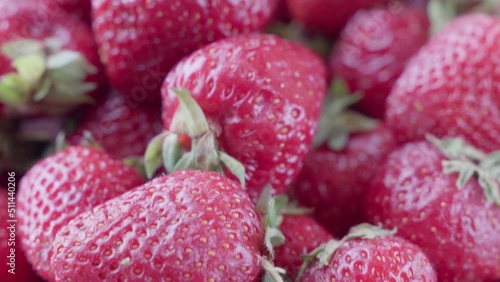 Ripe red strawberries with green leaves, macro
