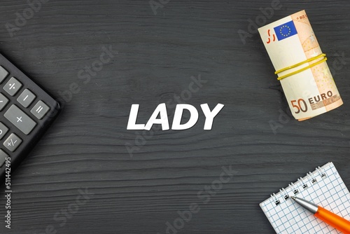 LADY - word (text) and euro money on a wooden background, calculator, pen and notepad. Business concept (copy space).