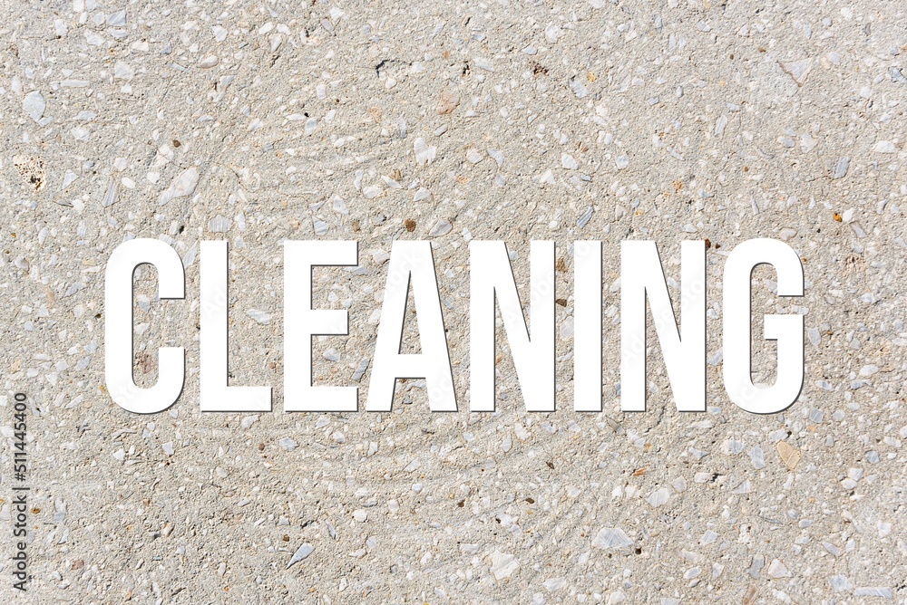 CLEANING - word on concrete background. Cement floor, wall.