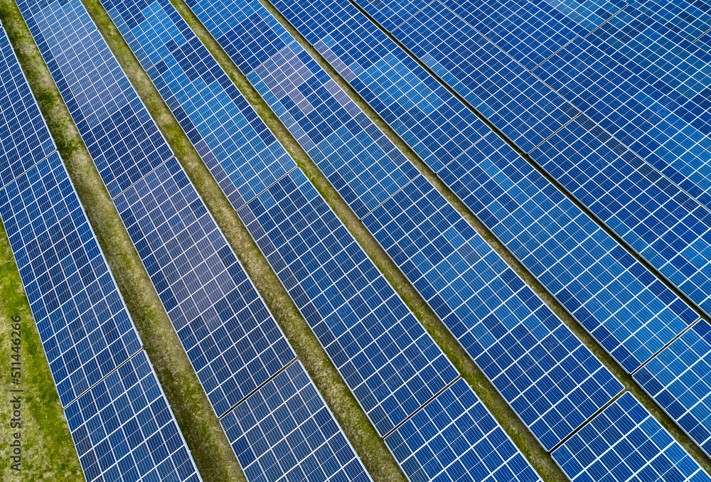 solar panel field at work with sun reflection solar panel field at work with sun reflection