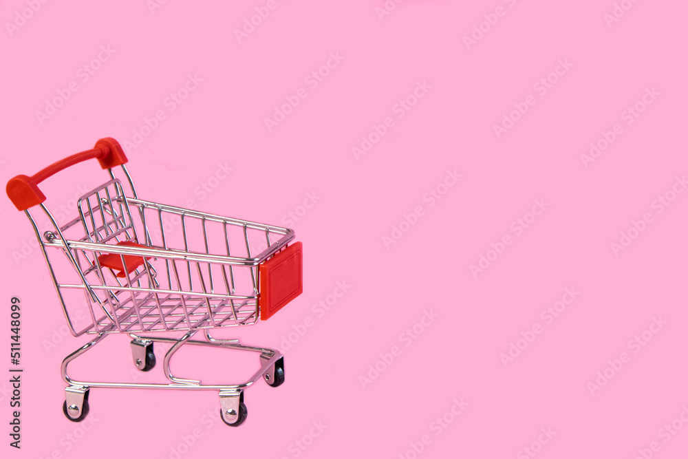 Shopping trolley, cart empty on pink background. Promotions, sales, shopping . The concept of Promotions, sales, shopping, advertising, ad, mocap, place for text High quality photo. High quality photo Shopping trolley, cart empty on pink background. Promotions, sales, shopping . The concept of Promotions, sales, shopping, advertising, ad, mocap, place for text High quality photo. High quality photo