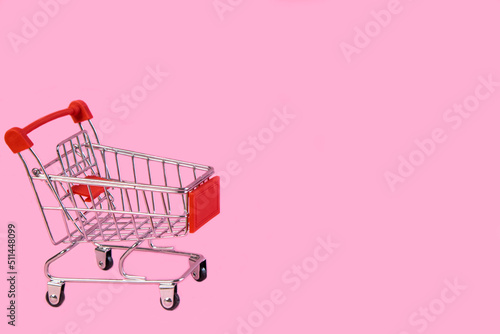 Shopping trolley, cart empty on pink background. Promotions, sales, shopping . The concept of Promotions, sales, shopping, advertising, ad, mocap, place for text High quality photo. High quality photo