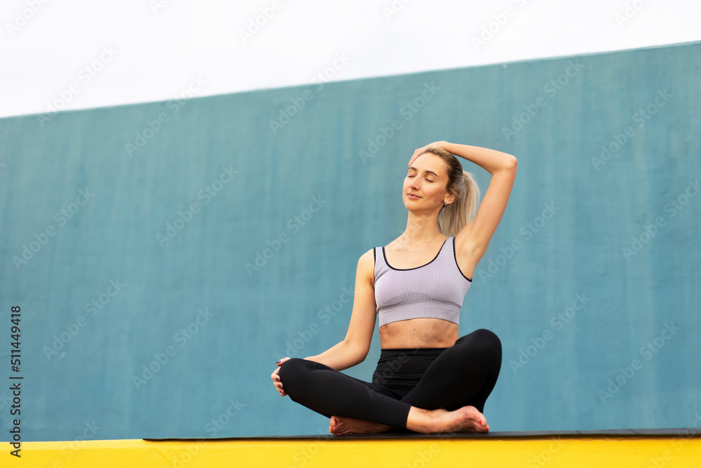 Young woman doing stretching exercise after running outside. Healthy lifestyle