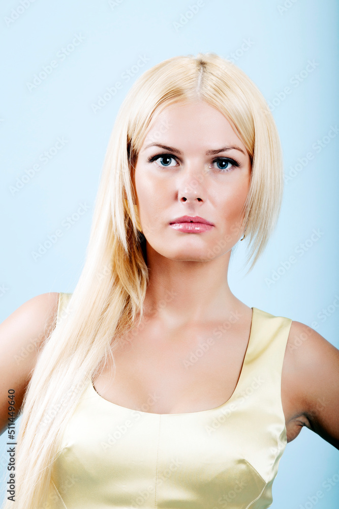 Young Confident Female Model is Posing Against Blue Background Young Confident Female Model is Posing Against Blue Background