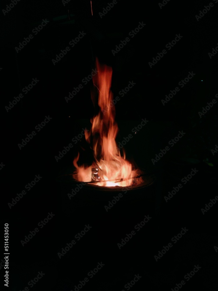 fire from burning wood in a drum at night