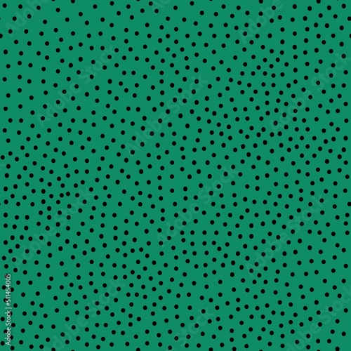 seamless abstract pattern. small black dots . Green background. vector texture. fashionable print for textiles and wallpaper.