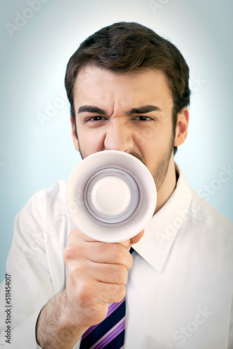 Aggressive Young Businessman is Shouting Out Loud