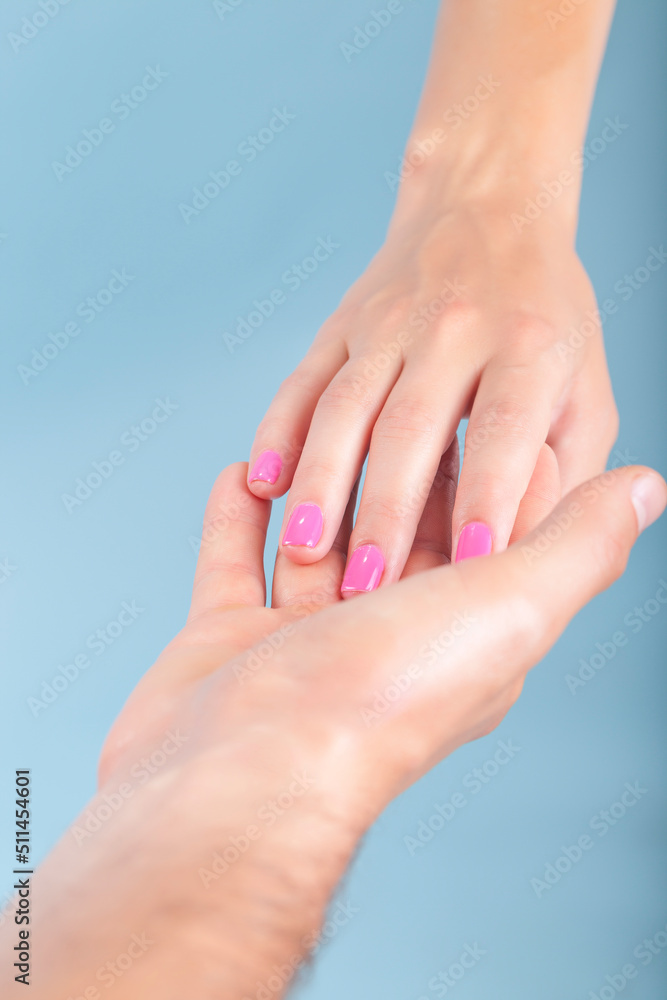 Hands are Touching Each Other Against Blue Background Hands are Touching Each Other Against Blue Background