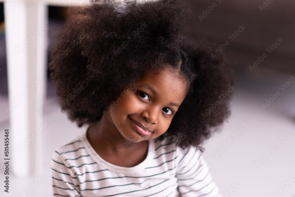 Close up of face cute young african girl with curly hair looking to camera Close up of face cute young african girl with curly hair looking to camera