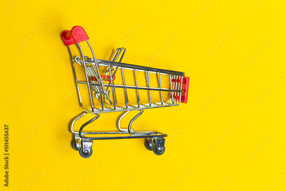 Empty Trolley Design Shopping or Sale Concepts. Shopping cart placed Over Trendy Yellow Background With Space for Text. Empty Trolley Design Shopping or Sale Concepts. Shopping cart placed Over Trendy Yellow Background With Space for Text.