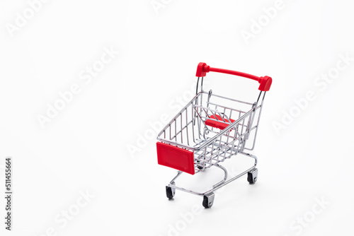 Savings and Sale Ideas. One Empty Trolley Shopping or Sale Cart Placed Over Seamless Solid White Background With Space for Text © danmorgan12