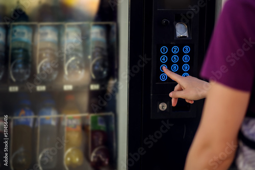 Hand presses button of vending machine. Self-used technology and consumption concept