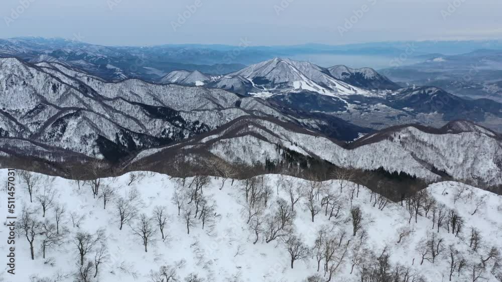 aerial panoramic of snowy mountain peak range in nagano japan during cloudy day aerial panoramic of snowy mountain peak range in nagano japan during cloudy day