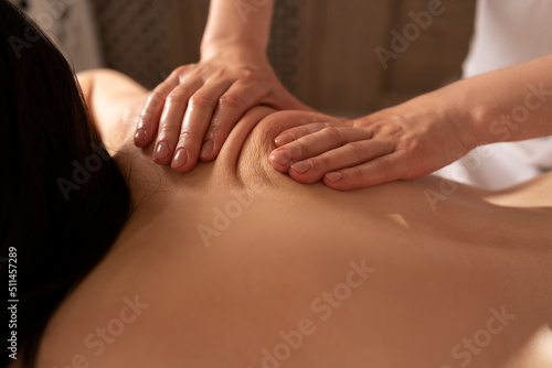 Deep tissue massage close-up. Woman having massage of body in the spa salon. Charming lighting. beauty treatment