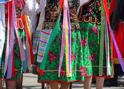 Women in tradtional colorful folk costumes from Krakow region in Poland photo