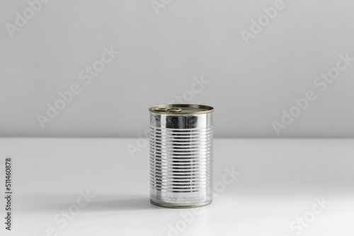 food, eating and preserve concept - close up of tin can with preserve on table