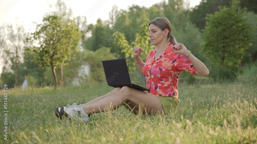Young woman straightens her back looking at screen of her laptop. Young woman straightens her back looking at screen of her laptop.